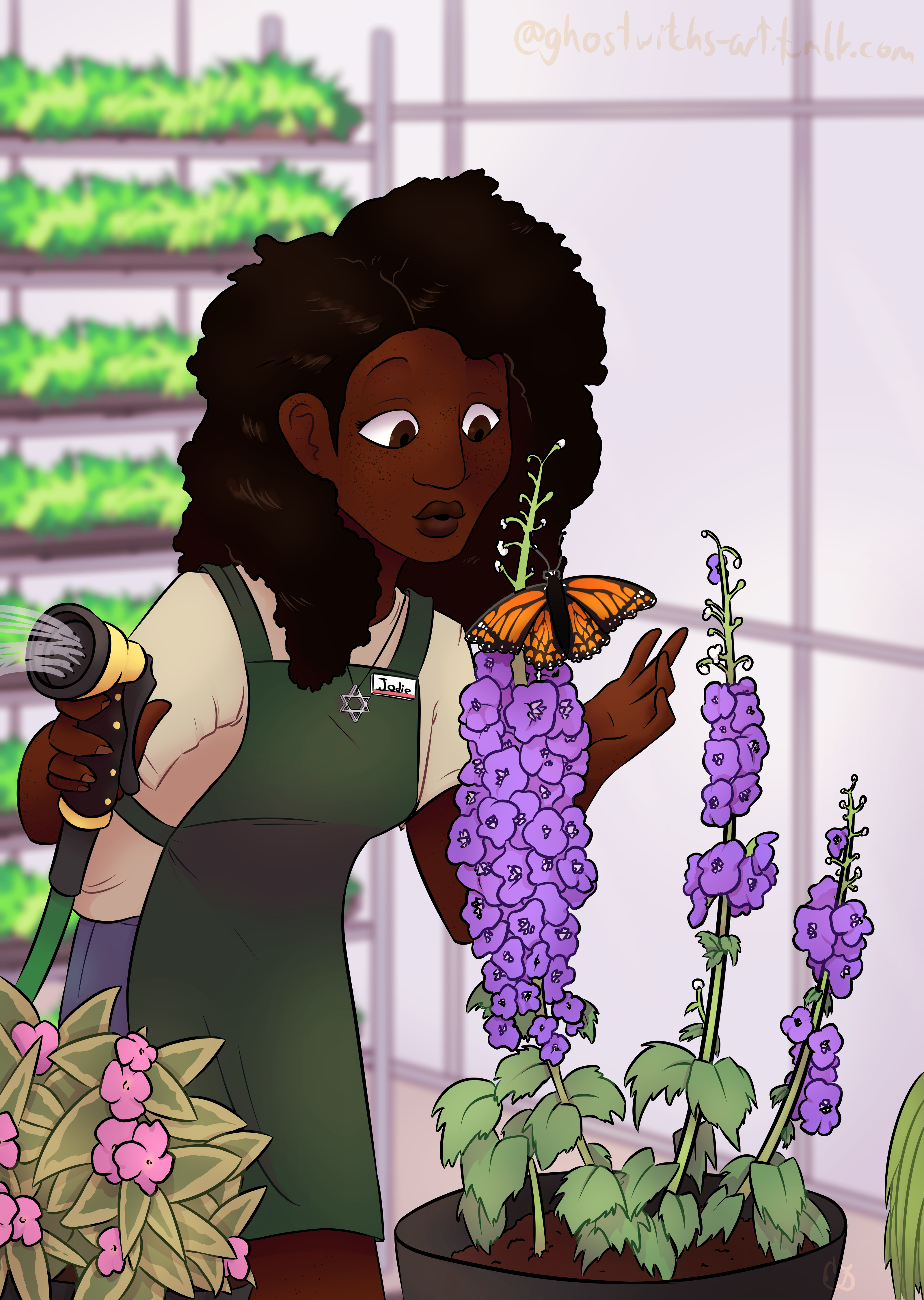 Jodie admiring a butterfly while watering plants in a greenhouse.